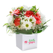 Evoking the essence of a sunny afternoon stroll down Tolworth Broadway, this colourful bouquet brings together gleaming white daisies and ruffled coral carnations, each bloom brimming with gentle vitality. Baby's breath dances between the main flowers, its dainty clusters reminiscent of local wildflowers in spring, while generous, glossy leaves frame the bouquet and lend a sense of lush, garden-like abundance. The occasional purple-frosted bud peeks from the side, suggesting the thoughtful, layered detail lovingly included by a local Tolworth florist. All are presented upright in a classic white gift bag with ribbon handles, strikingly highlighted against a pure white backdrop that draws the eye to the fresh colours within. Whether destined for a birthday celebration, an anniversary in Berrylands, or a sweet reminder of care, this arrangement radiates sincerity, freshness, and the kind of expert preparation that makes every delivery feel extra special throughout the Tolworth community.